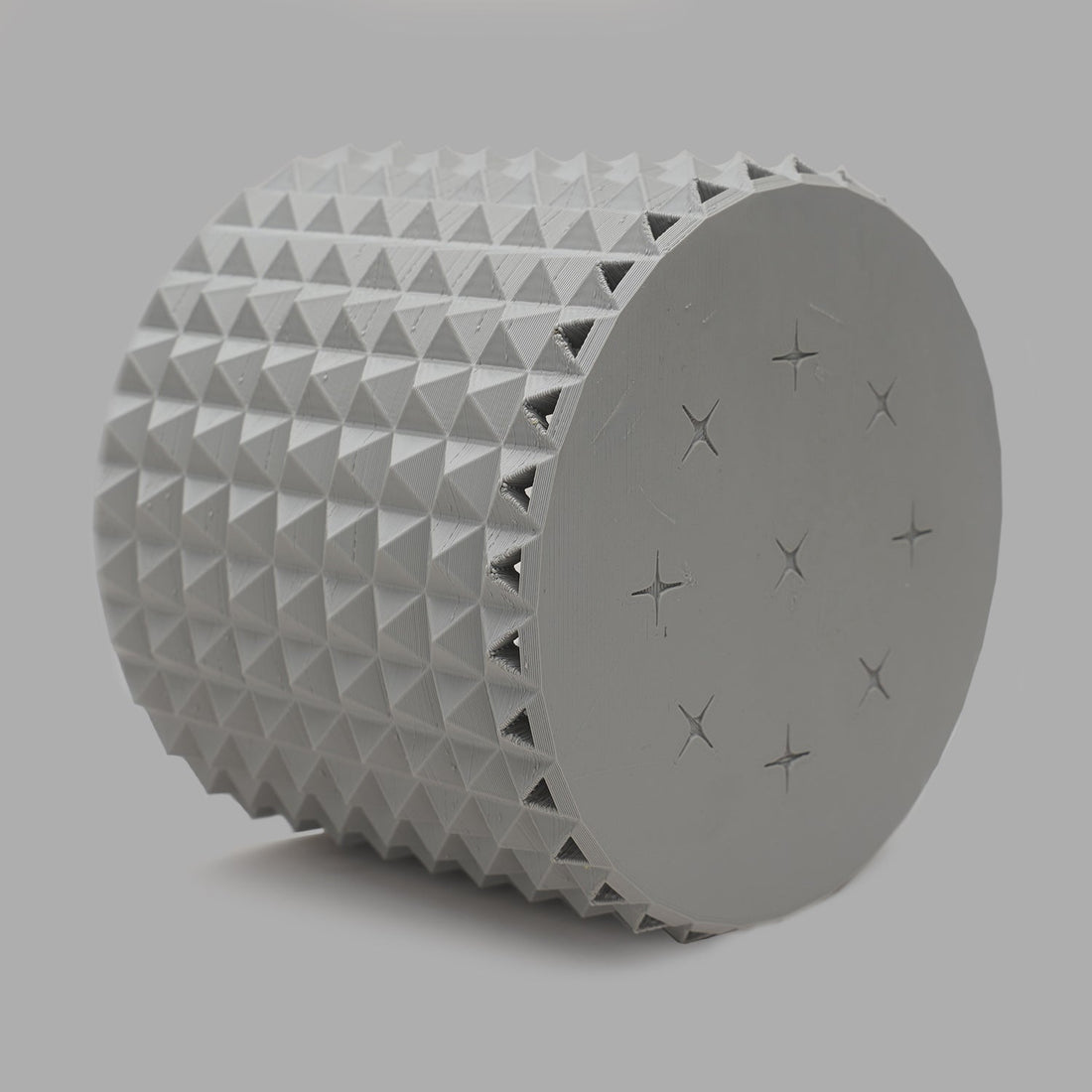 Light gray 3D-printed studded planter on a neutral background